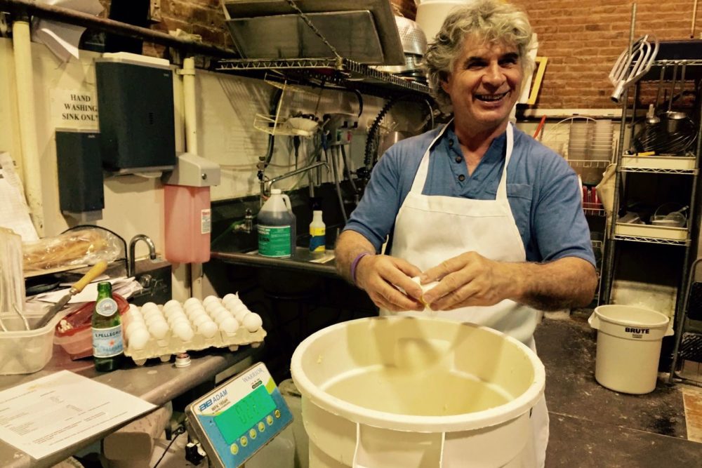 Richard Bourdon stands in front of a tub of dough
